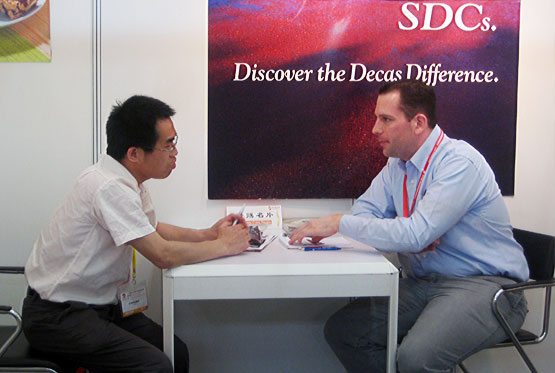 Alex Lindsay of AMI negotiates with a prospective customer at Bakery China, Shanghai, May 2010